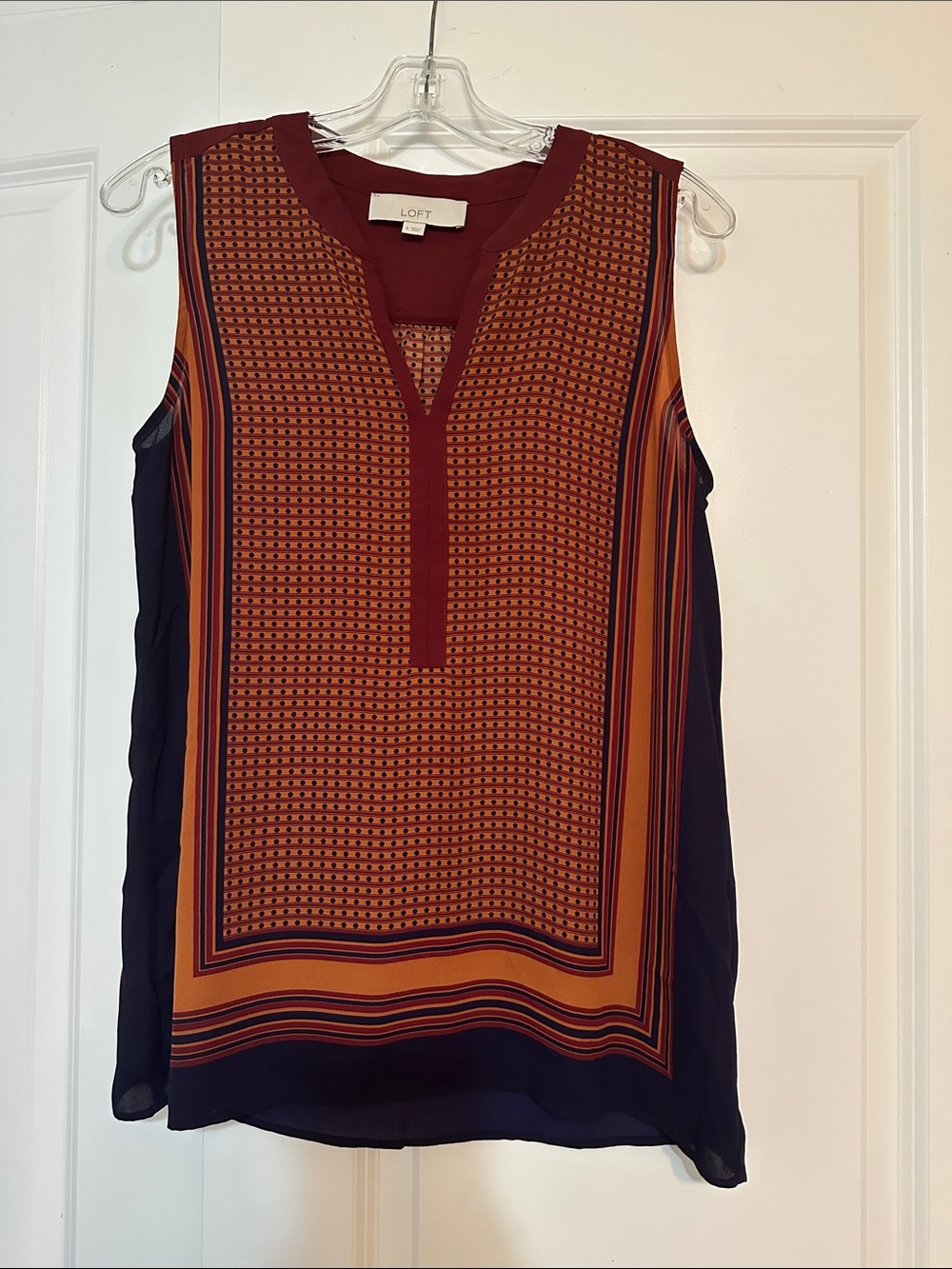 Sz S Loft navy sleeveless top featuring a geometric orange pattern and a v-neck.